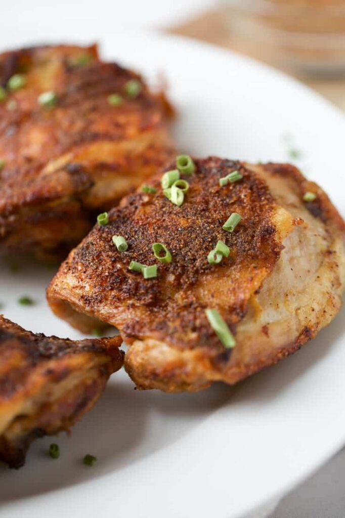 This is a picture of air fryer chicken thighs that are looking perfect and are keto 2.0 plus perfect to chase the hunger out of your mind with very low carb count