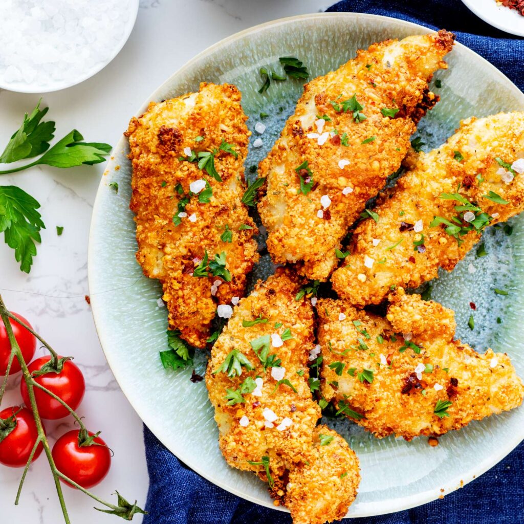 These chicken tenders will add another level of yum to your life.  You will never want to get fast food chicken tenders again, as you will be spoiled for life by these delicious chicken tenders.  Get ready to feel amazing after you do this and keep in mind if you want you can add ground pop pork rinds in a third bowl and dip to get an even crispier crust on these wonderful chicken tenders